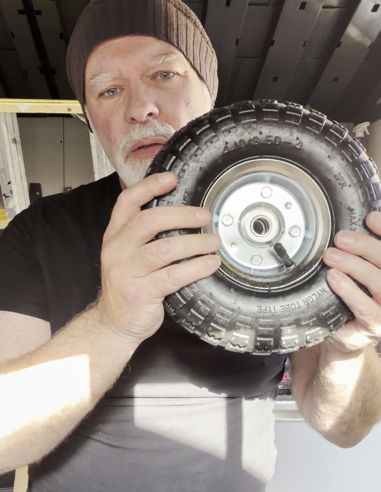 Brett in the shed in Lytham holding one of Prototype 01's chunky wheels